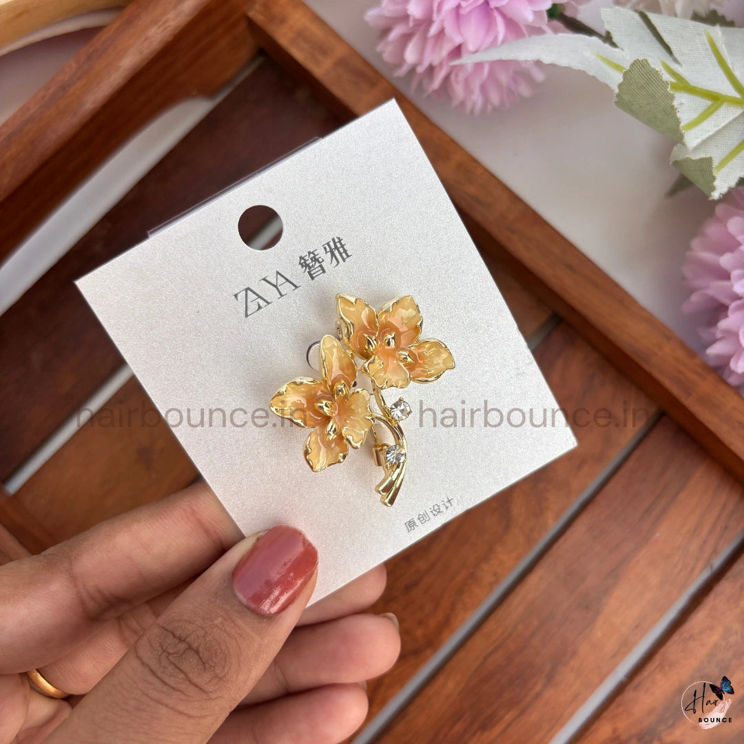 Elegant Gold Floral Brooch with Crystal Accent