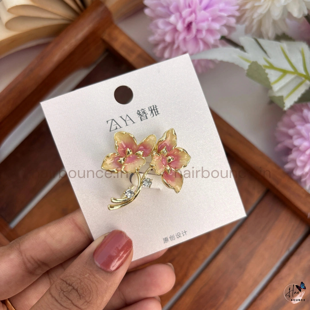 Elegant Gold Floral Brooch with Crystal Accent