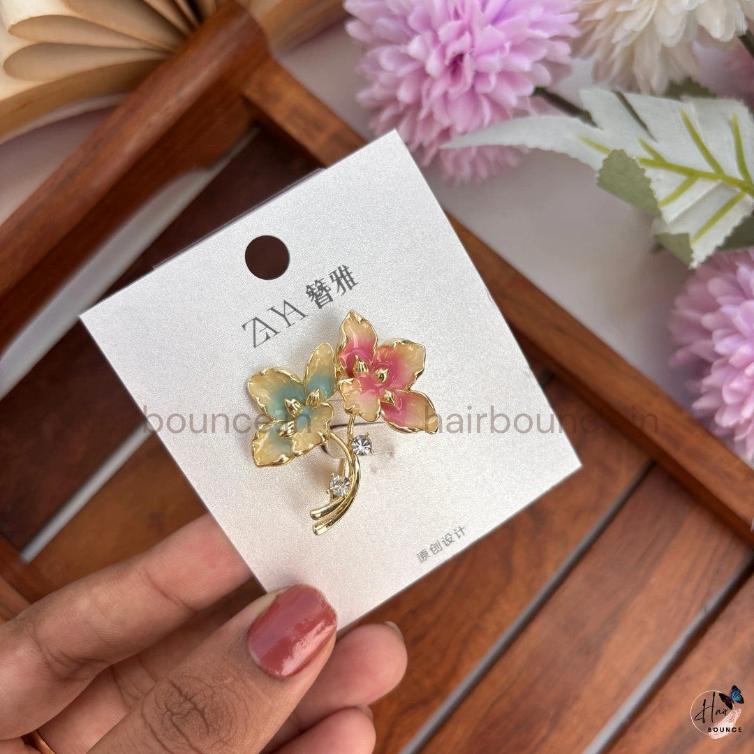 Elegant Gold Floral Brooch with Crystal Accent