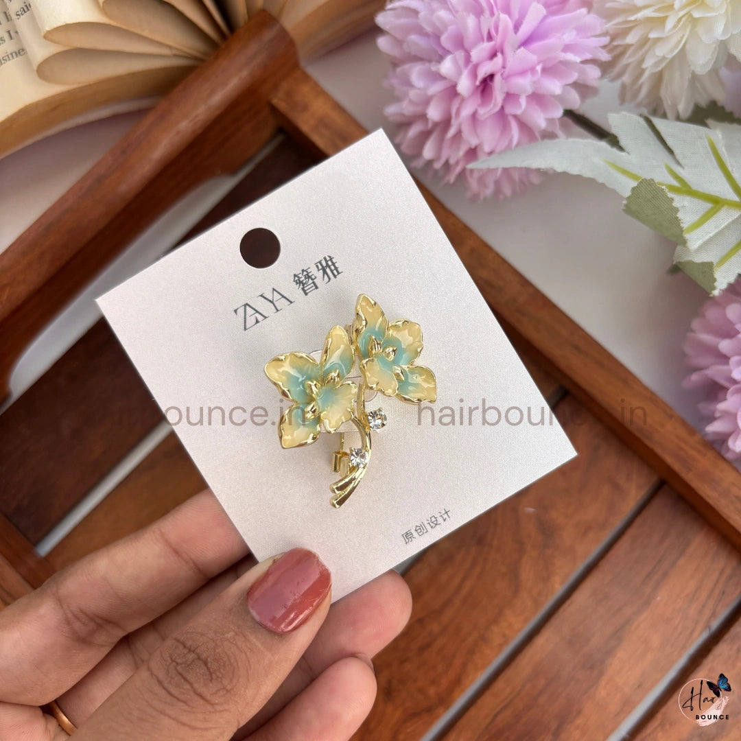 Elegant Gold Floral Brooch with Crystal Accent